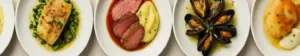 Seks fransk-nordiske brasserieanretninger på klassisk hvidt porcelæn side om side, set lige ovenfra.